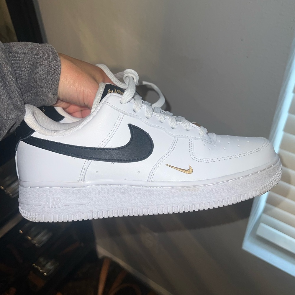 Nike Air Force 1. Women’s size 7, black and gold.